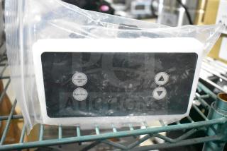 Brand new scratch and dent control box, sealed in plastic, with visible on/off and function buttons for easy operation.