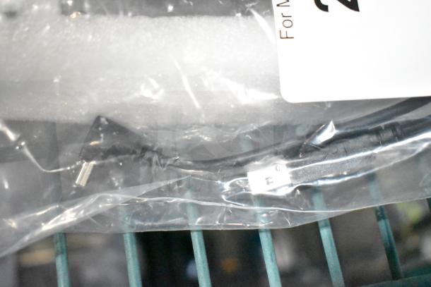 Brand new control box with minor scratches and dents, sealed in plastic with visible connectors.