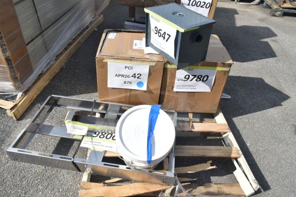 6 scratch and dent items, including Watts WD-4-THD grease trap and Canarm 12" exhaust fan on pallets, labeled for auction.