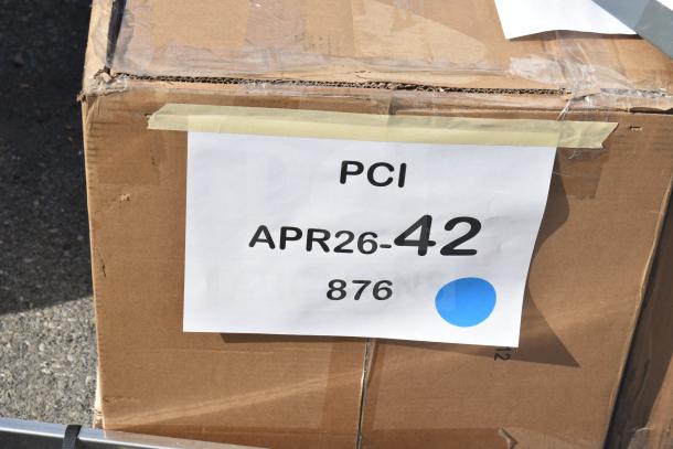 Box labeled "PCI APR26-42 876" containing 6 new scratch and dent items, including Watts WD-4-THD 8 lb. grease trap.