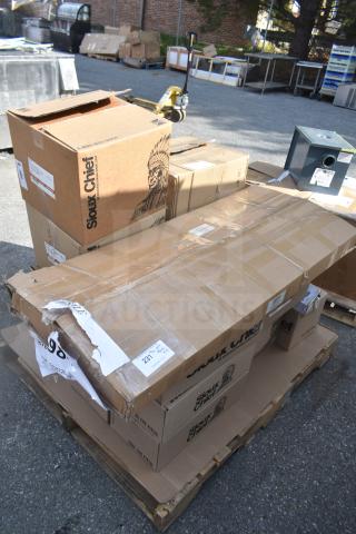 Cardboard boxes on a pallet with Sioux Chief branding, containing new scratch and dent items, including tube hangers and brackets.