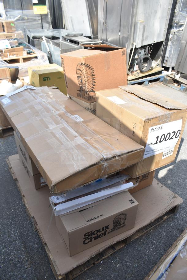 13 new scratch and dent items on pallet, including Sioux Chief tube hangers and brackets, boxed and wrapped.