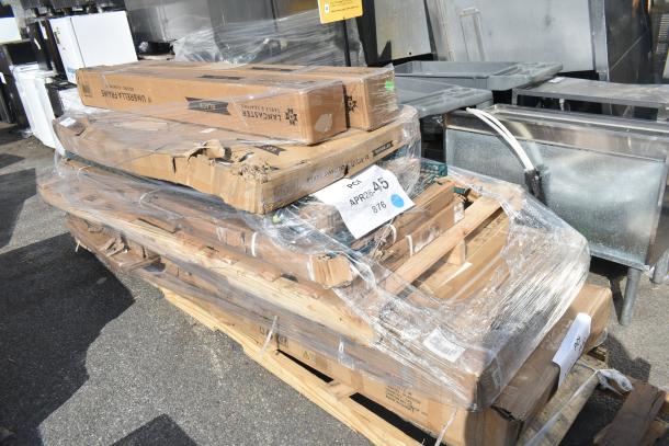11 brand new scratch and dent items including wire shelves and bi-folding table, packaged on a pallet. Labels include "Langcaster."