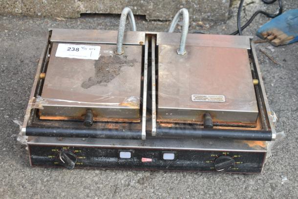 Cecilware TSG2F countertop double panini press, 230 volts, 1 phase, metal finish, used condition with visible wear and labels.