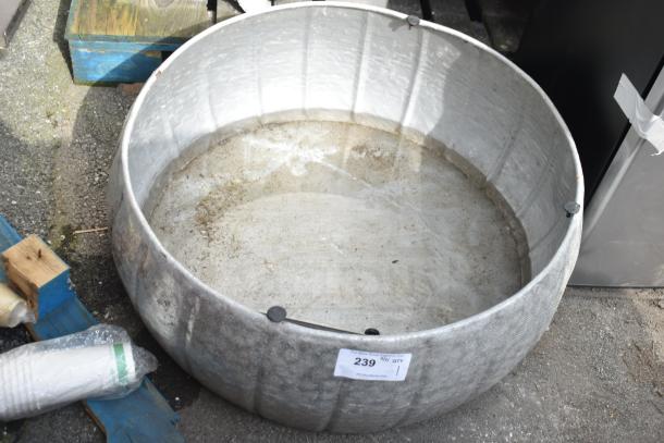 Large round metal bin with weathered appearance. Label reads "239 /4/ QTY" indicating auction details.