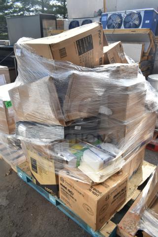 Stack of boxes on a pallet, wrapped in plastic. Boxes labeled for cups, tumblers, and envelopes, showing scratch and dent items.