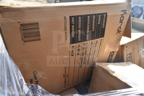 Cardboard boxes labeled "Karat" showing product specs for cups, in scratch and dent condition, partially wrapped.