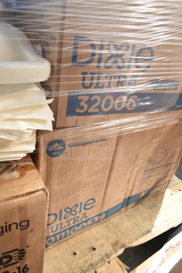 Boxes of Dixie Ultra items on a pallet, wrapped in plastic. Includes brand new scratch and dent cups, tumblers, envelopes.