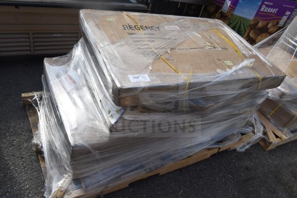 Stack of 7 new scratch and dent items, including tabletops, wrapped on a pallet. Regency brand markings visible.