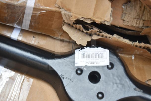 Damaged cardboard box with black metal component, barcode label visible. Item part of auction for scratch and dent lot.