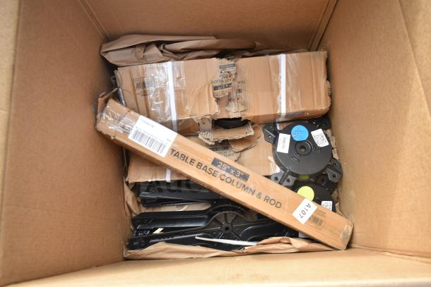 Box containing new scratch and dent items, including table base parts and other hardware, some packaging damaged.