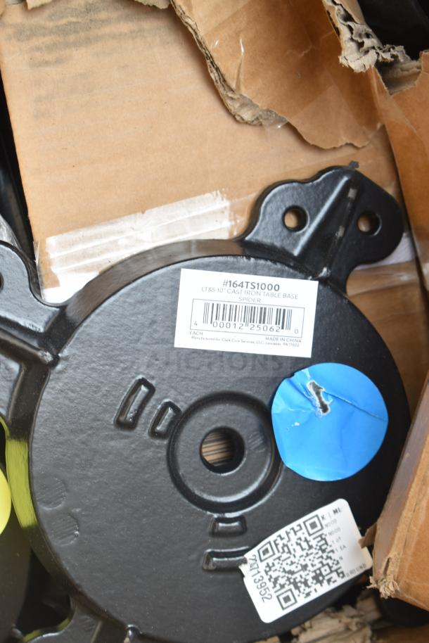 Black cast iron table base with a label marked #164TS1000, made by Clark Core Services. Item is in new condition with packaging.