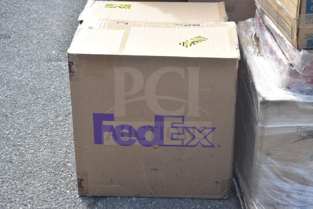 Brown FedEx box containing Lancaster Table & Seating table base parts; marked as scratch and dent.