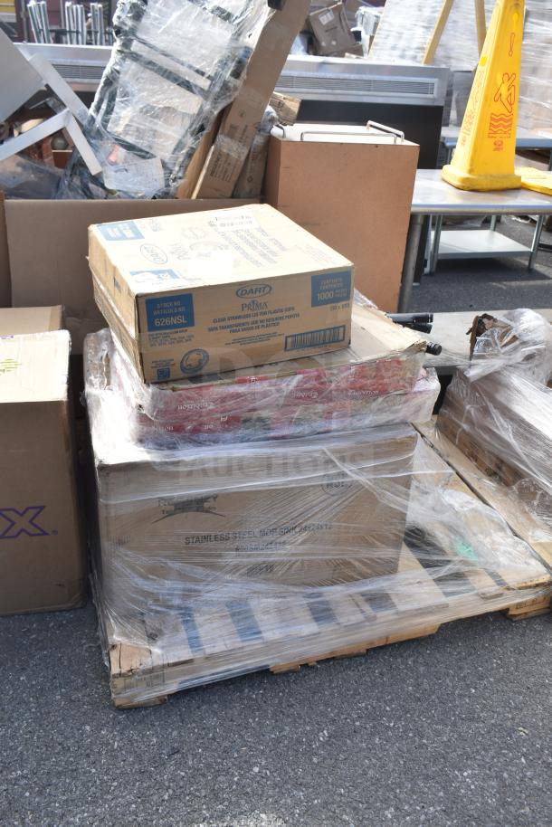 Brand new scratch and dent items on pallet, including Regency stainless steel mop sink, table, and packaged goods.