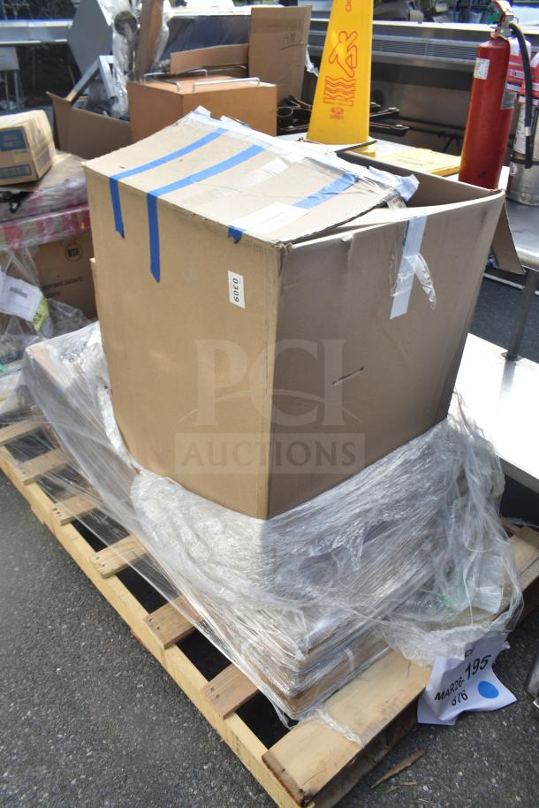 Cardboard box on wooden pallet, wrapped in plastic. Label marked "MAR26-195." Contains new scratch and dent items.