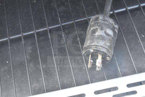 Killion Metal Commercial Merchandiser plug, 208/230V, 1 Phase, shown on metal surface, used condition.