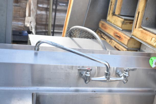 Stainless steel single bay sink with chrome faucet and handles, "NOTHING IN SINK" label, in used condition.