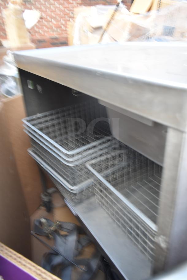 Commercial counter with drawer, metal under shelf, and wire baskets. Rugged condition, ideal for storage and organization.