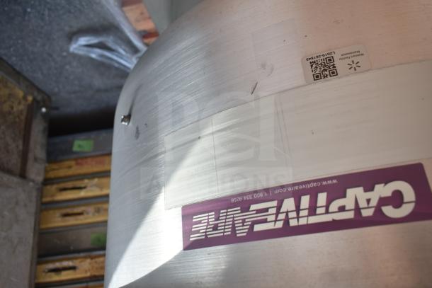 CaptiveAire commercial rooftop mushroom exhaust fan with visible branding label and maintenance QR code on the metal surface.