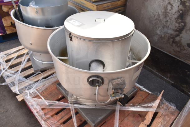 CaptiveAire commercial rooftop mushroom exhaust fan, stainless steel, on a pallet, visible wiring and labels.