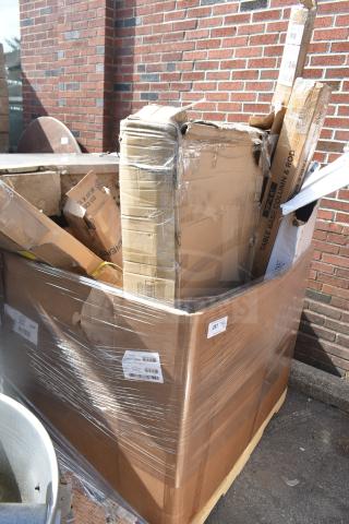 Large cardboard box with various new scratch and dent items inside, including pizza peels and table base pieces. Box labeled "257".
