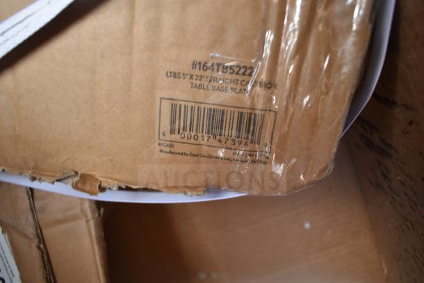 Cardboard box labeled "#164TB5222" shows LT&S 5" x 22" Cast Iron Table Base Plate, barcode visible, minor damage.