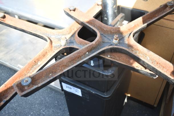 5 items including rusted metal table base pieces and a black poly trash can. Visible tag reads "259".