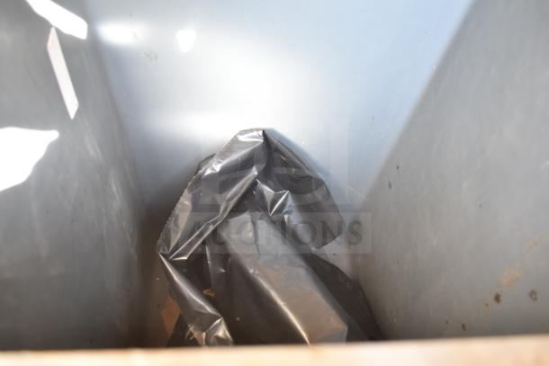 Trash can shell with trash deposit hole and door, interior view showing condition, gray plastic lining inside.