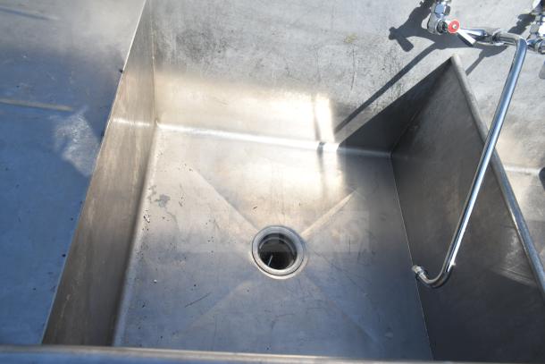 Commercial 2 Bay Sink with dual drain boards, stainless steel, integrated faucet, visible wear, ideal for kitchens.