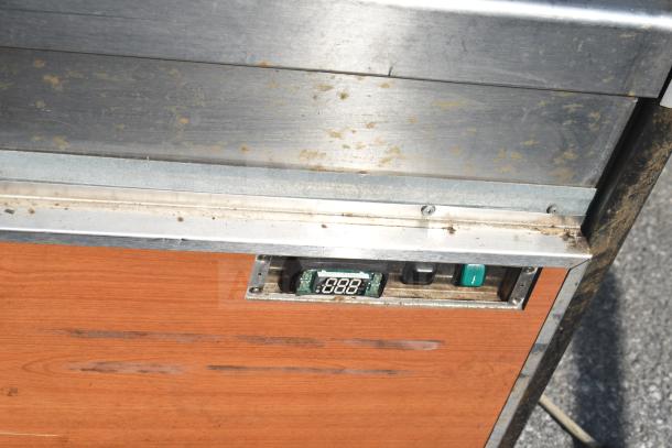 Commercial Grab N Go Merchandiser with digital display and control panel, exhibits wear on metal and wood surfaces.