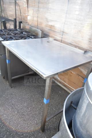 Stainless steel commercial table, sturdy frame, light wear, with "HORAGUS" label on side. Ideal for kitchen use.