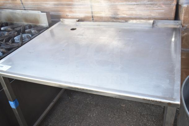 Stainless steel commercial table with backsplash and hole for utilities, by Hobart, in good condition.