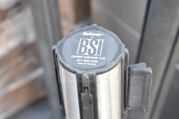 BSI Beltway stanchion with metal finish, featuring "Crowd Control LLC" label and contact details. Good condition.
