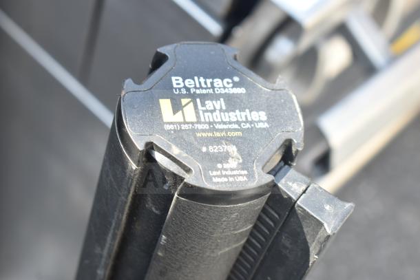 Black stanchion from Lavi Industries, model Beltrac, with visible logo and contact info. Made in USA.