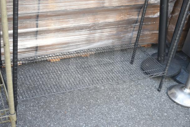 Black finish 3-tier wire shelving unit, sturdy design. Buyer must dismantle. Consider freight charges.