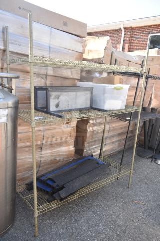 Tan finish 3-tier wire shelving unit with contents. Used condition. Buyer must dismantle. Freight charges apply.