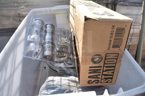 Tan 3-tier wire shelving unit with contents including packaged hardware and a Sani Station box, buyer must dismantle.