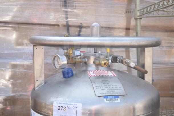 NuCO2 beverage carbonation tank with pressure gauge and connection valves. Metal exterior, emergency shut-off tag visible. Buyer pickup only.
