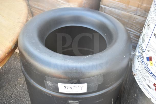 Rubbermaid Trash Can, black, circular, durable plastic, with visible label and identification sticker, in good condition.