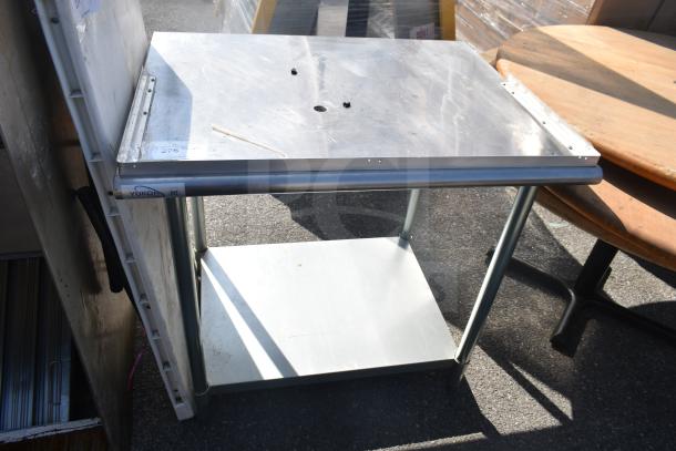 Commercial table with stainless steel top, under shelf, Yukon brand, minor wear, ideal for kitchen or workspace use.