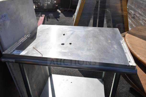 Stainless steel commercial table with under shelf, Yukon NSF label, surface wear, visible auction tag "276".