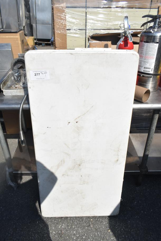 White folding table with a rectangular shape, showing minor scuffs and dirt. Auction tag labeled "277" attached.