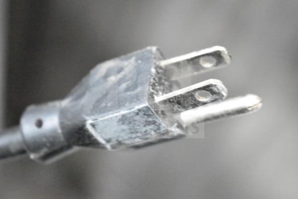 Close-up of a power plug connected to the Manitowoc SD0452A commercial ice machine, highlighting 115V, 1-phase compatibility.