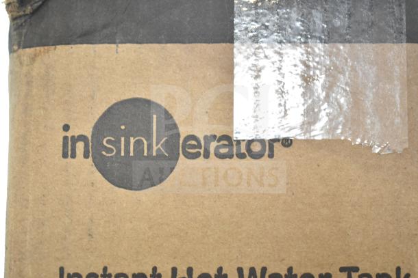 Cardboard box with Insinkerator logo and text "Instant Hot Water Tank." Box condition shows dents and scratches.