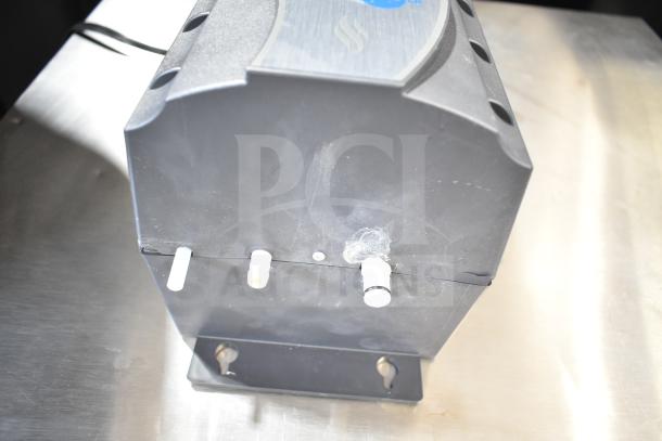 Brand new Insinkerator HWT-00 instant hot water tank; visible scratches; black exterior; three connection points.