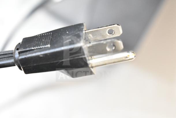 Plug of Insinkerator HWT-00 Instant Hot Water Tank, brand new with minor cosmetic scratches, showing detail of the power cord.