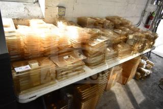 Brand new lot of amber drop-in bin lids, FG202P22AMBR, FG221P86AMBR. Includes tabletop and floor items, neatly stacked.