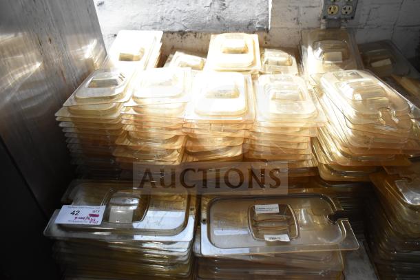 Lot of brand new amber-colored drop-in bin lids, models FG202P22AMBR, FG221P86AMBR. Includes tabletop and floor items.