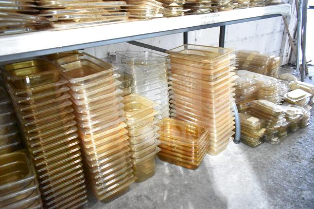 Brand new amber drop-in bin lids, models FG202P22AMBR, FG221P86AMBR, stacked on shelves. Tabletop and floor items included.