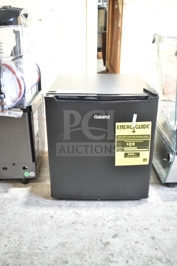 Brand new Galanz 1063897 1.7 Cu ft black mini fridge, one-door, slight scratches, visible energy guide label.